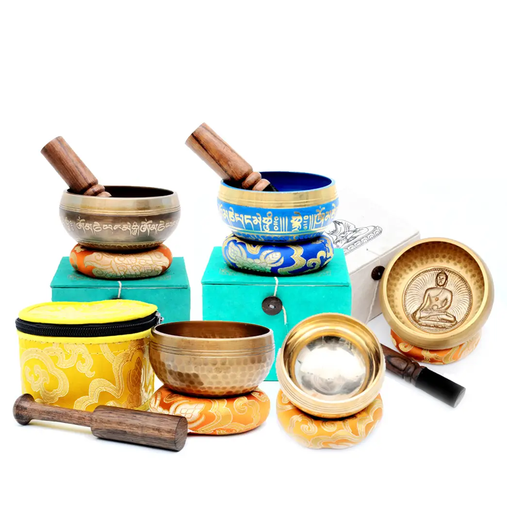 Collection of hand-casted singing bowls with different sizes and engravings