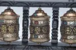 Prayer wheel with Om Mani Padme Hum and Eight Auspicious Symbols on wooden frame