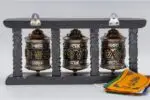 Prayer wheel with Om Mani Padme Hum and Eight Auspicious Symbols on wooden frame