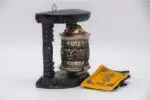 Tibetan prayer wheel with Ashtamangala embossing on copper and carved wood