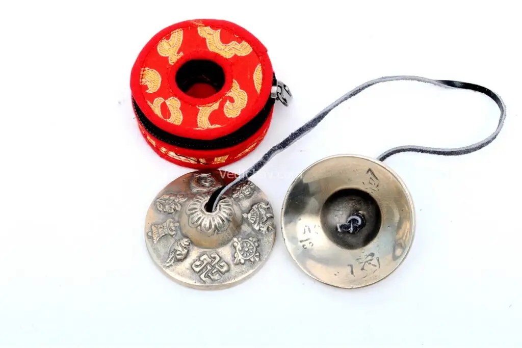 Austamangal Embossed Tibetan Chimes – handcrafted from 7-metal alloy with detailed engravings of the Eight Auspicious Symbols (Austamangal), producing a pure, resonant tone for meditation and rituals.
