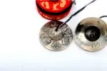 Austamangal Embossed Tibetan Chimes – handcrafted from 7-metal alloy with detailed engravings of the Eight Auspicious Symbols (Austamangal), producing a pure, resonant tone for meditation and rituals.