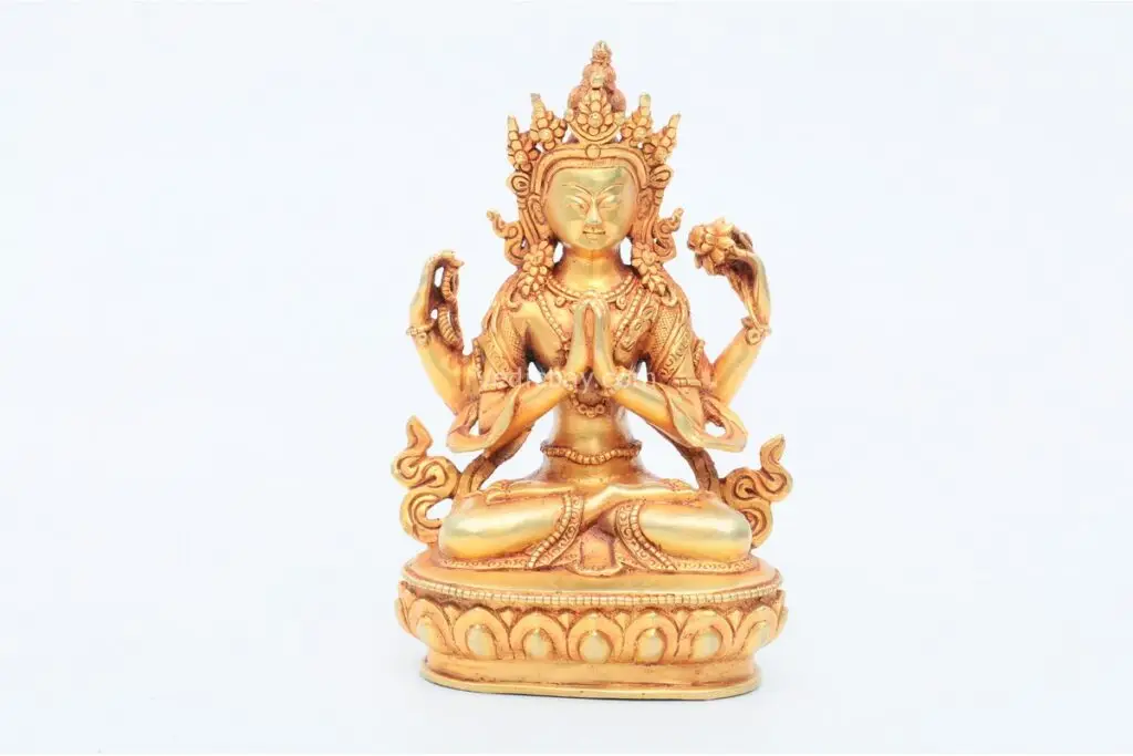 Handcrafted Chenrezig Statue with four arms in a seated posture – made from brass with detailed ornamentation, symbolizing compassion and the embodiment of Avalokiteshvara.