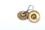 Dragon Embossed Tingsha Cymbals – handcrafted from a traditional 7-metal alloy with detailed dragon engravings, producing a clear, high-pitched tone ideal for meditation, energy clearing, and spiritual rituals.