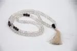 Himalayan Crystal, Garnet & Amethyst Mala – handcrafted 108-bead prayer necklace combining clear Himalayan quartz for purity, garnet for vitality, and amethyst for spiritual insight. Ideal for meditation, chakra alignment, and energy healing.