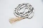 Howlite Stone Mala – handcrafted 108-bead prayer necklace made from natural howlite stones, known for calming the mind, easing stress, and promoting emotional healing. Ideal for meditation, mantra chanting, and mindfulness.