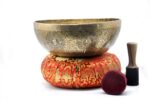 Large handmade singing bowl with Buddha engraving, Tibetan mantras, and mandala base