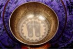 Extra large handmade singing bowl featuring Buddha Foot in center, mantra etching, and Eight Auspicious Symbols
