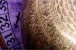 Extra large handmade singing bowl featuring Buddha Foot in center, mantra etching, and Eight Auspicious Symbols