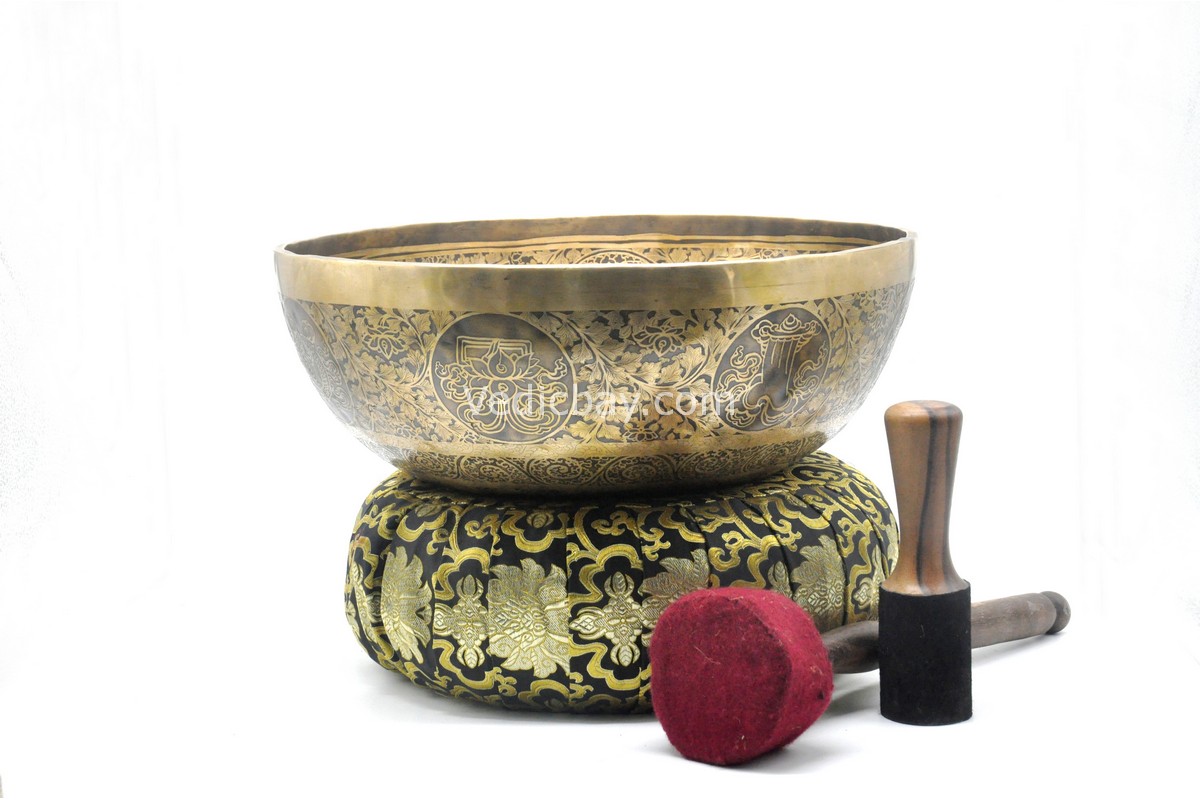 Large handmade singing bowl with Buddha foot carving, chakra symbols, Ashtamangala, and Shree Yantra