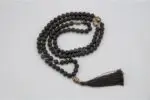 Lava Stone Mala with Buddha Head – handcrafted 108-bead prayer necklace made from natural lava stones with a Buddha head bead centerpiece, symbolizing grounding, strength, and spiritual awareness. Ideal for meditation and daily mindfulness.