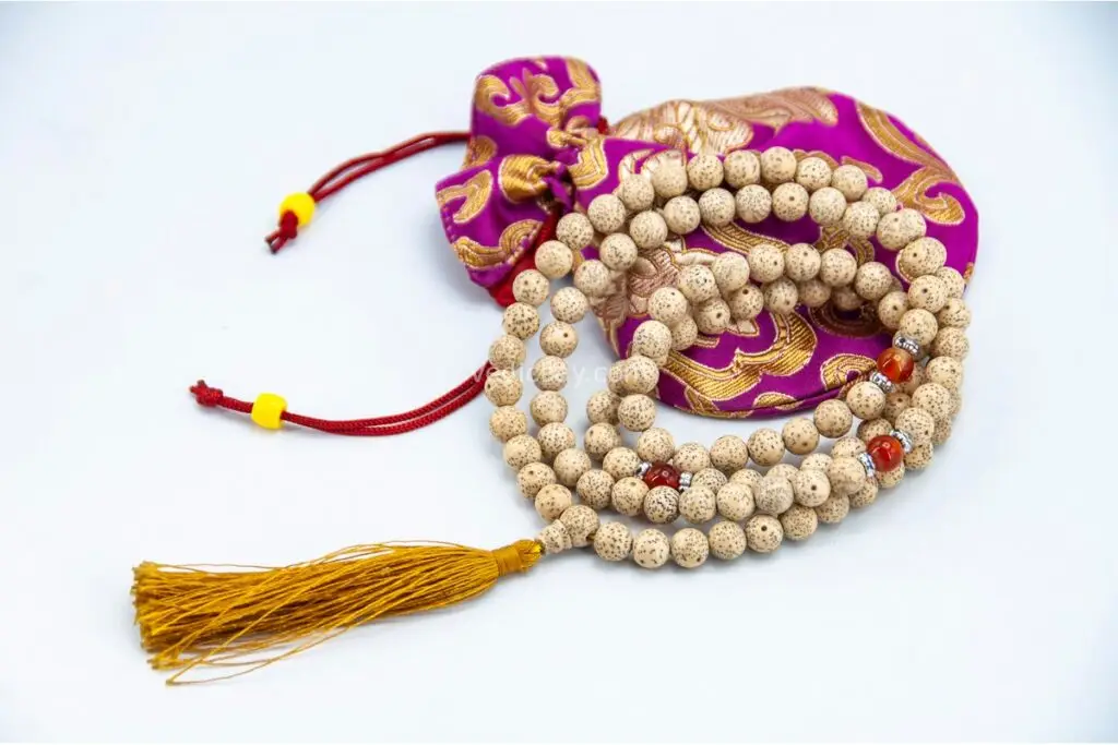 Lotus Mala with Red Coral Stone – handcrafted 108-bead prayer necklace featuring lotus accents and vibrant red coral beads, symbolizing passion, transformation, and spiritual awakening. Ideal for meditation, mantra chanting, and chakra healing.