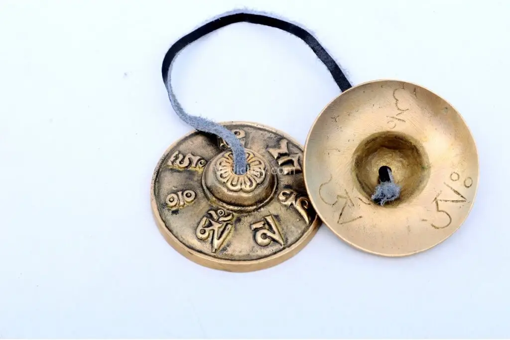 Mantra Embossed Tingsha Cymbals – handcrafted from 7-metal alloy with sacred mantra engravings, producing a pure, resonant tone ideal for meditation, sound healing, and spiritual rituals.
