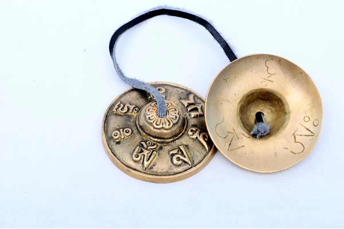 Mantra Embossed Tingsha Cymbals – handcrafted from 7-metal alloy with sacred mantra engravings, producing a pure, resonant tone ideal for meditation, sound healing, and spiritual rituals.