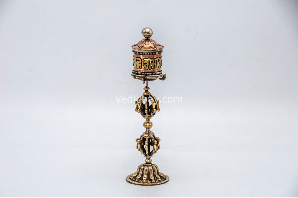 lose-up of engraved Om Mani Padme Hum mantra on Tibetan prayer wheel Bottom view of Vajra brass base on Buddhist prayer wheel Prayer wheel being held and spun – traditional dharma practice