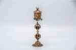 lose-up of engraved Om Mani Padme Hum mantra on Tibetan prayer wheel Bottom view of Vajra brass base on Buddhist prayer wheel Prayer wheel being held and spun – traditional dharma practice