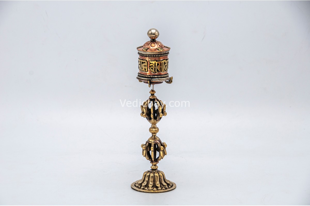 lose-up of engraved Om Mani Padme Hum mantra on Tibetan prayer wheel Bottom view of Vajra brass base on Buddhist prayer wheel Prayer wheel being held and spun – traditional dharma practice
