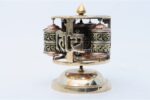 Tibetan Dharma Wheel featuring 4 copper prayer wheels with internal scrolls and embossed auspicious symbols. Handmade in Nepal.
