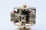 Tibetan Dharma Wheel featuring 4 copper prayer wheels with internal scrolls and embossed auspicious symbols. Handmade in Nepal.