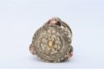 Tibetan Dharma Wheel featuring 4 copper prayer wheels with internal scrolls and embossed auspicious symbols. Handmade in Nepal.