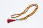 Picture Jasper, Coral & Turquoise Mala – handcrafted 108-bead prayer necklace combining grounding picture jasper, energizing coral, and protective turquoise for balance, vitality, and spiritual harmony. Ideal for meditation and healing rituals.