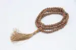 Raktu Seed Mala – handcrafted 108-bead prayer necklace made from natural raktu seeds, symbolizing protection, grounding, and spiritual focus. Ideal for meditation, mantra chanting, and daily spiritual practice