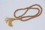 Raktu Seed Mala – handcrafted 108-bead prayer necklace made from natural raktu seeds, symbolizing protection, grounding, and spiritual focus. Ideal for meditation, mantra chanting, and daily spiritual practice
