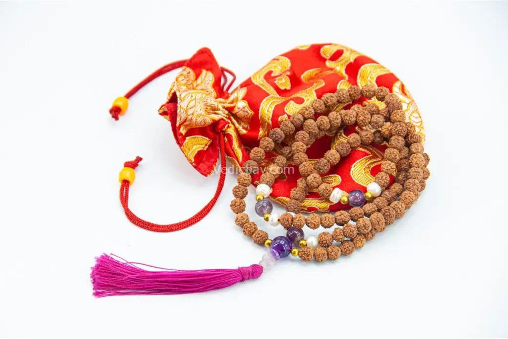 Rudraksha Mala with Pearl & Amethyst – handcrafted 108-bead prayer necklace combining sacred rudraksha seeds with calming pearl and spiritual amethyst, symbolizing protection, peace, and higher awareness. Ideal for meditation and spiritual growth.