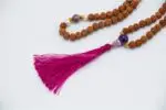 Rudraksha Mala with Pearl & Amethyst – handcrafted 108-bead prayer necklace combining sacred rudraksha seeds with calming pearl and spiritual amethyst, symbolizing protection, peace, and higher awareness. Ideal for meditation and spiritual growth.