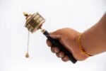 Copper prayer wheel engraved with Om Mani Padme Hum and lucky symbols
