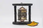 Wall hanging Tibetan prayer wheel with Austamangal and carved wooden base