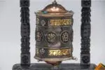 Wall hanging Tibetan prayer wheel with Austamangal and carved wooden base