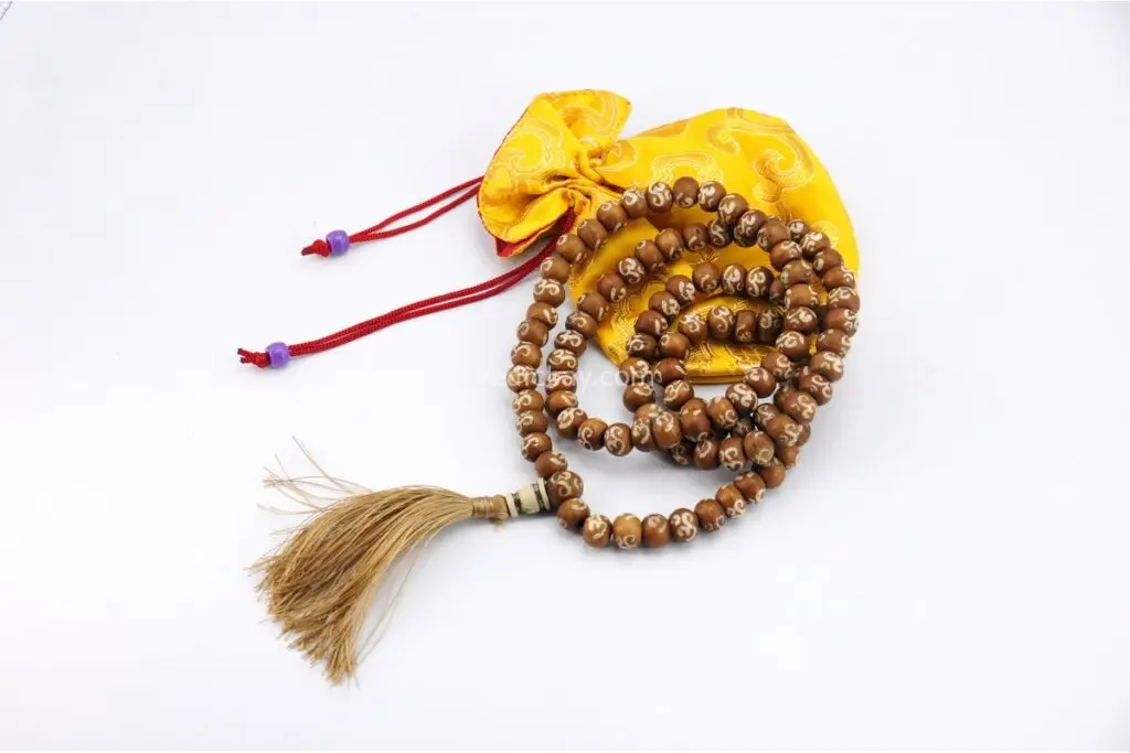 Yak Bone Om Mala – handcrafted 108-bead prayer necklace made from ethically sourced yak bone, featuring carved Om symbols. Represents impermanence, spiritual strength, and sacred sound. Ideal for mantra chanting, meditation, and protection rituals.
