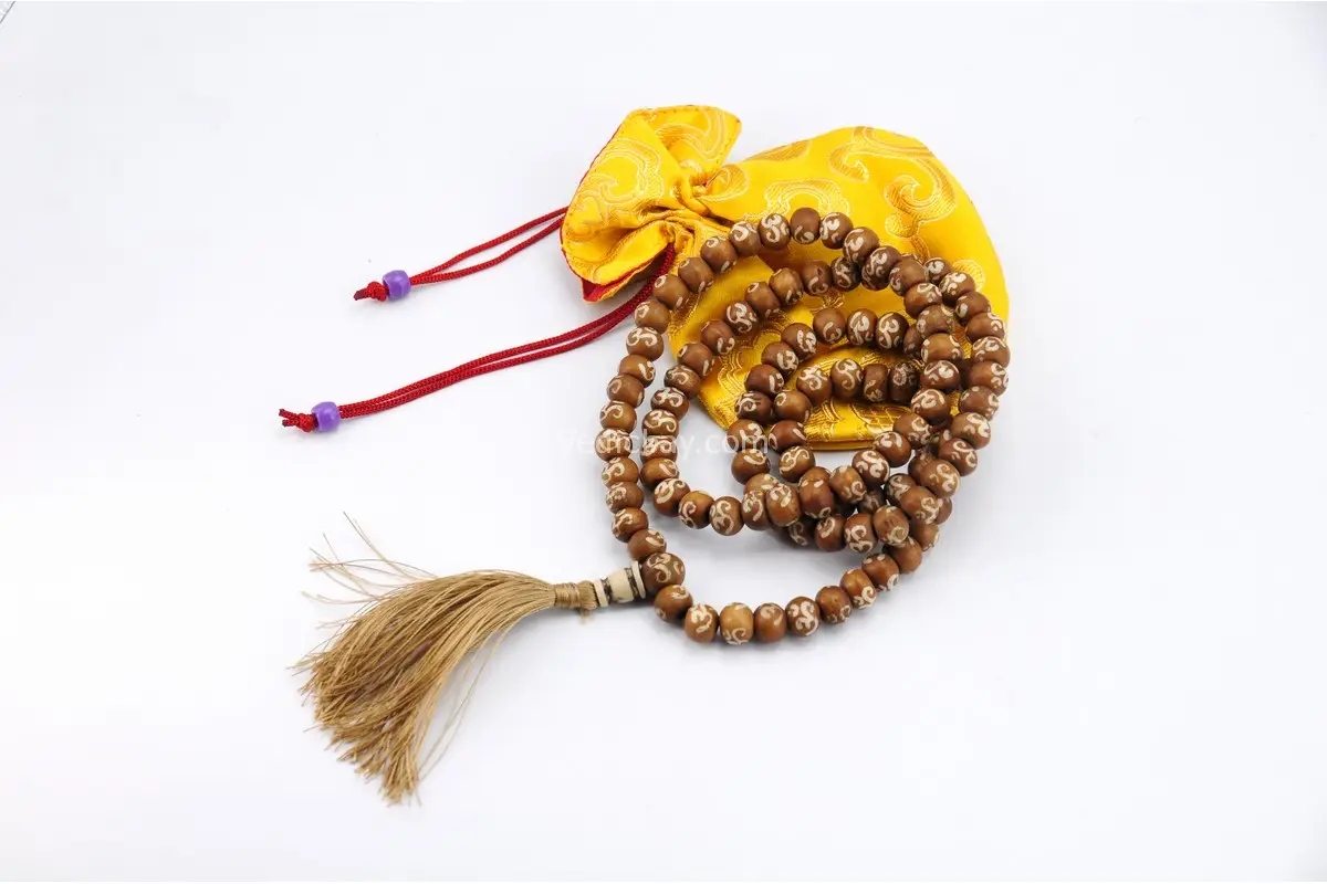 Yak Bone Om Mala – handcrafted 108-bead prayer necklace made from ethically sourced yak bone, featuring carved Om symbols. Represents impermanence, spiritual strength, and sacred sound. Ideal for mantra chanting, meditation, and protection rituals.