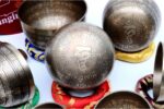 7 Chakra Tibetan Mantra Etched Singing Bowl Set of 7 with mallets, cushions, carry box, and bracelet – handmade in Nepal