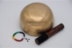 7 inch handmade Jhumka singing bowl crafted in Nepal with 7 chakra stone bracelet, mallet, and cushion