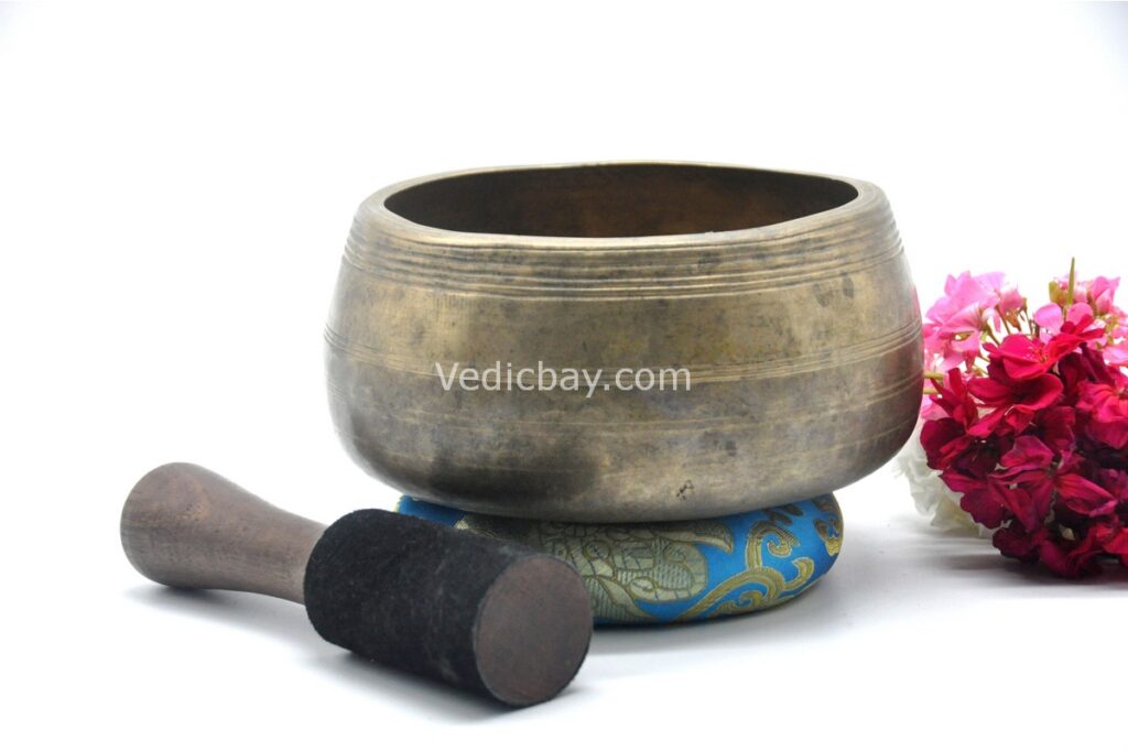 Collected antique Mani singing bowl showing natural patina, aged surface marks, and authentic texture